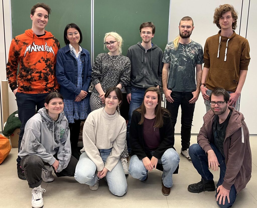 Photo of active Fachschaft members in the Summer Semester 2023 in front of a chalkboard